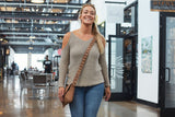 Woman with handmade leather purse over shoulder