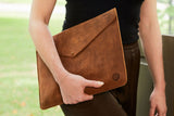woman carrying Handmade leather laptop sleeve high quality leather goods