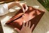woman using Handmade leather laptop sleeve high quality leather goods