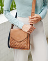 Woman carrying the basket weave crossbody bag on shoulder