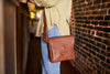 Woman with handmade leather purse on shoulder