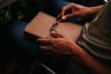 man hands holding leather covered Bible