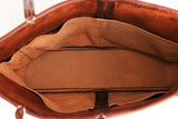 Inside view of Handmade leather tote bag with strap closure in the color persimmon